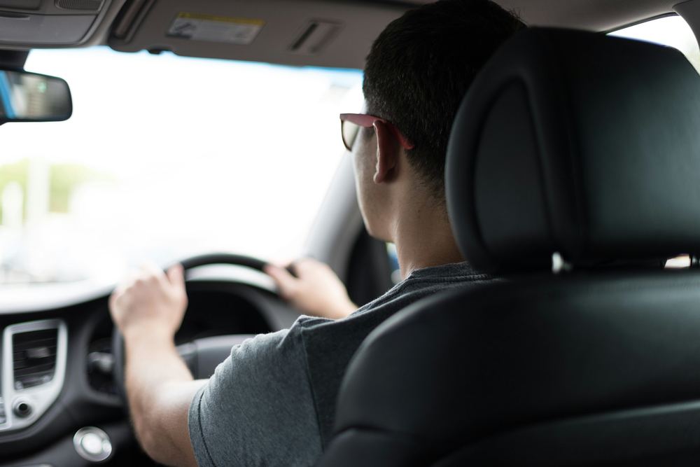 Student driver with hands on the steering wheel